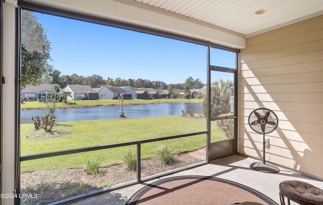 unfurnished sunroom featuring a water view