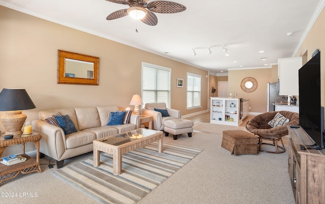 living room with crown molding, rail lighting, light colored carpet, and ceiling fan