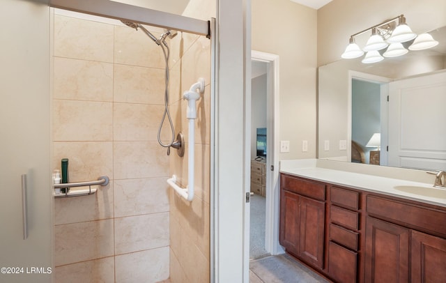 bathroom with vanity and tiled shower