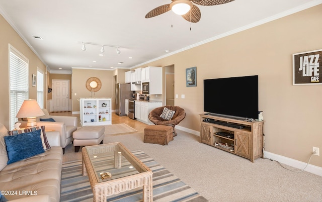 living room with ceiling fan, ornamental molding, and light carpet