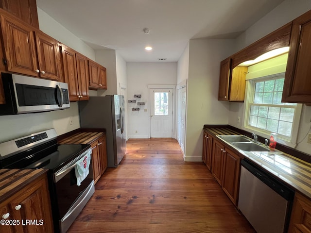 3769 Rice Shire Rd, Ridgeland, SC 29936 - kitchen featuring stainless steel appliances, dark wood-style flooring, dark countertops, recessed lighting, and brown cabinets