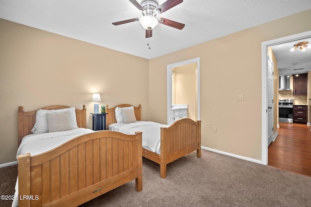 bedroom with baseboards, carpet, ceiling fan, and ensuite bathroom