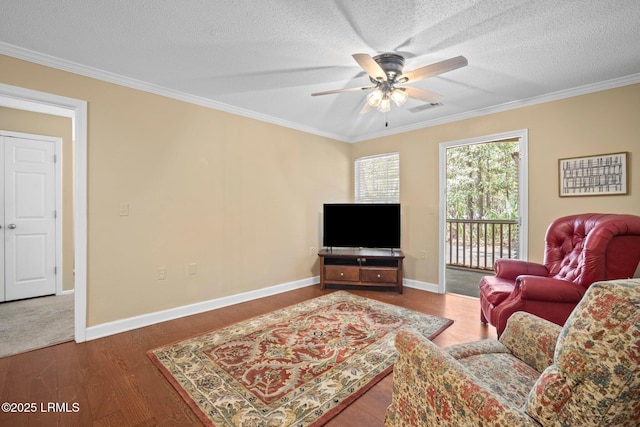 living room with visible vents, a ceiling fan, a textured ceiling, and ornamental molding