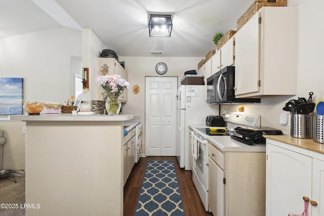 897 Fording Island Rd Unit 2708, Bluffton, SC 29910 - kitchen with white electric range oven, light countertops, dark wood-style floors, and a peninsula