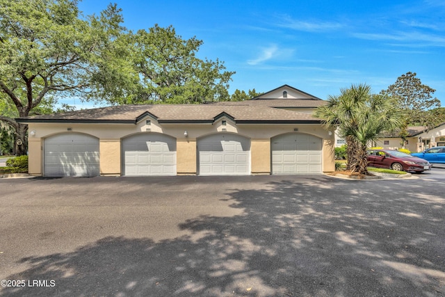 897 Fording Island Rd Unit 2708, Bluffton, SC 29910 - view of front of house with stucco siding, community garages, and a shingled roof
