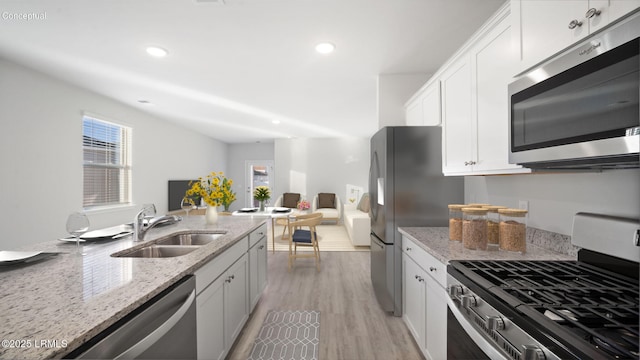 1449 Sanctum St, Ridgeland, SC 29936 - kitchen with appliances with stainless steel finishes, a sink, light wood-style floors, recessed lighting, and light stone countertops