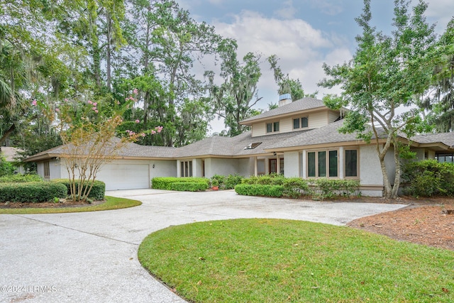 view of front of home featuring a garage and a front lawn