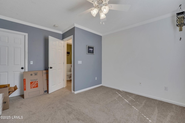 unfurnished bedroom featuring ornamental molding, light colored carpet, and ceiling fan