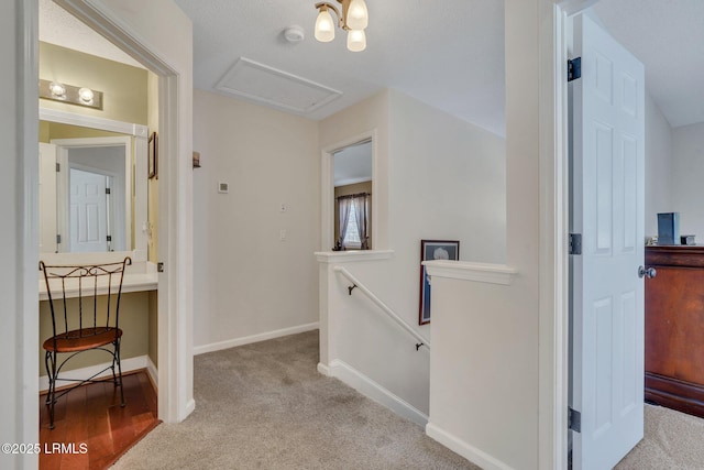 corridor featuring light colored carpet