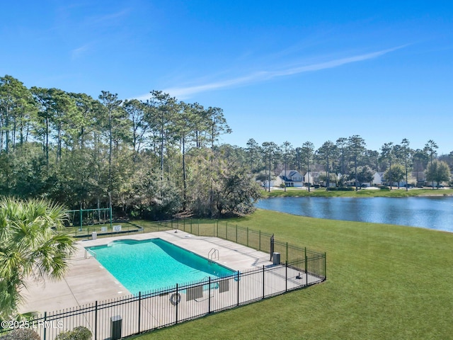 view of swimming pool featuring a water view, a patio area, and a lawn