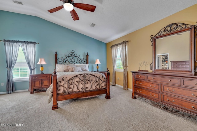 carpeted bedroom with lofted ceiling, a textured ceiling, multiple windows, and ceiling fan