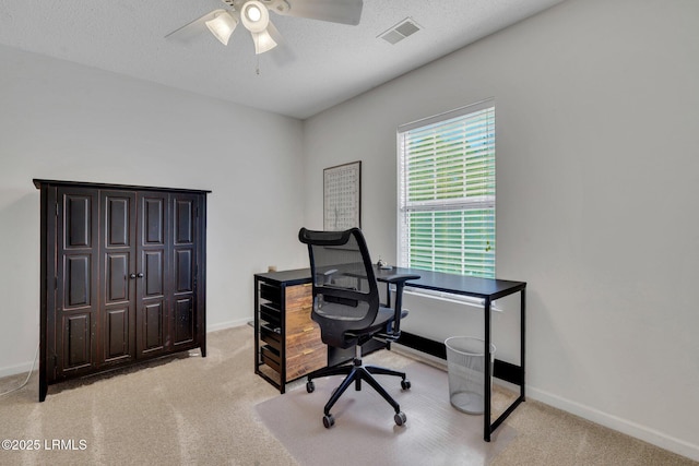 office area featuring ceiling fan, light colored carpet, and a textured ceiling