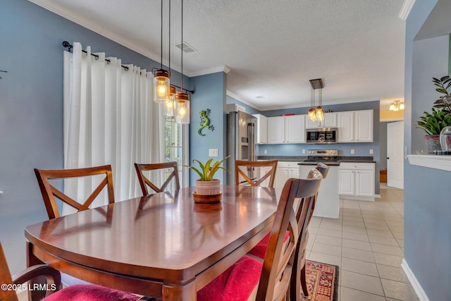 dining area featuring light tile patterned floors, crown molding, and a textured ceiling