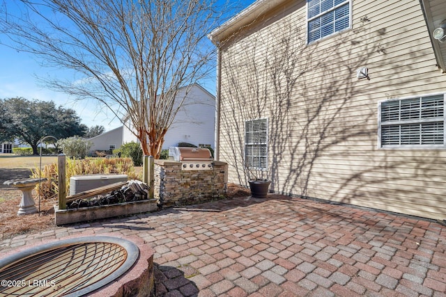 view of patio with a hot tub, a grill, and area for grilling