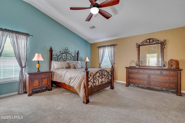 bedroom with ceiling fan, lofted ceiling, and light carpet