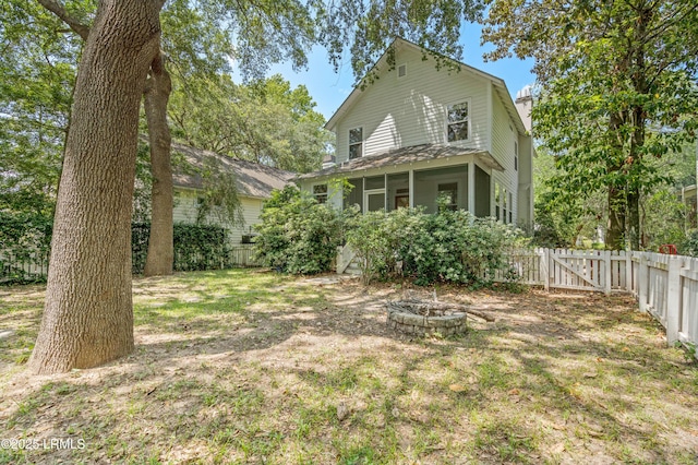 2654 Broad St, Beaufort, SC 29902 - view of front of house featuring an outdoor fire pit, a fenced backyard, and a gate