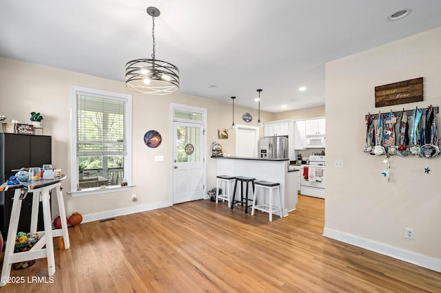 2654 Broad St, Beaufort, SC 29902 - kitchen with white appliances, baseboards, white cabinets, light wood-style floors, and recessed lighting