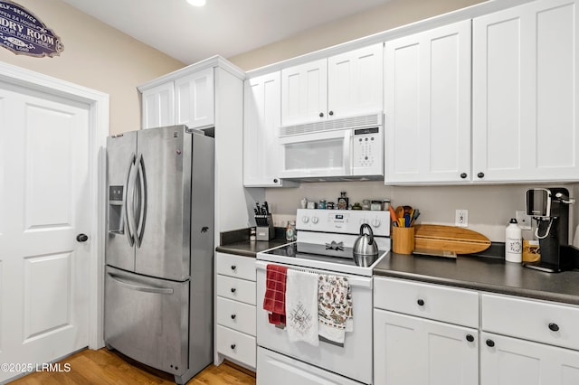 2654 Broad St, Beaufort, SC 29902 - kitchen featuring white appliances, dark countertops, white cabinetry, and light wood-style floors