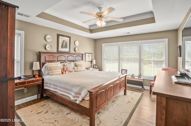 49 National Blvd, Beaufort, SC 29907 - bedroom with a raised ceiling, light wood finished floors, crown molding, and ceiling fan