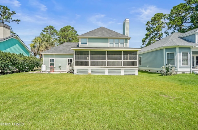 49 National Blvd, Beaufort, SC 29907 - back of property featuring a sunroom, a lawn, a chimney, and a shingled roof