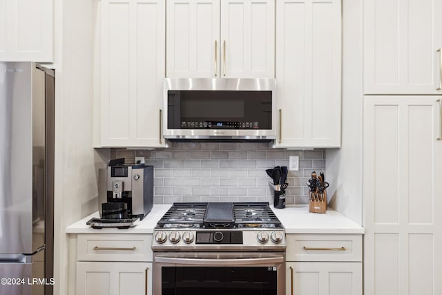 kitchen with white cabinetry, appliances with stainless steel finishes, and backsplash