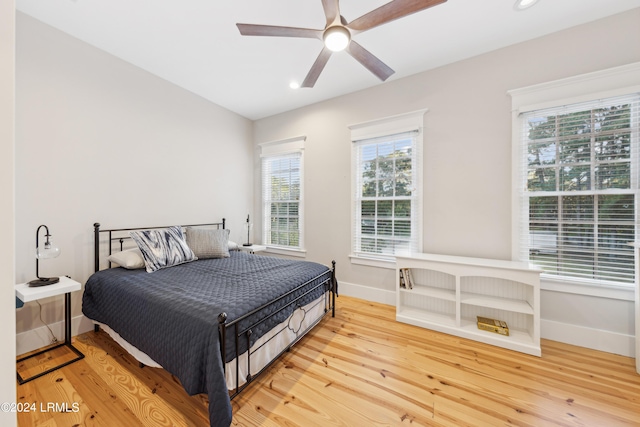 bedroom with hardwood / wood-style flooring and ceiling fan