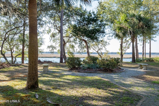 exterior space featuring a water view and a lawn