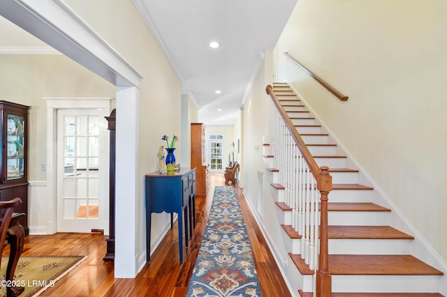 foyer entrance featuring ornamental molding, recessed lighting, stairs, and wood finished floors