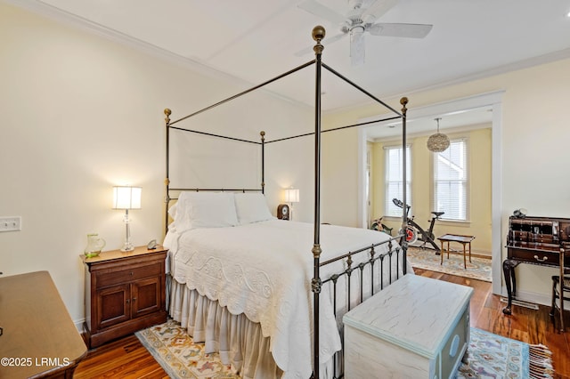 bedroom featuring ornamental molding, dark wood finished floors, and baseboards