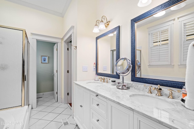 full bath with a stall shower, ornamental molding, and a sink