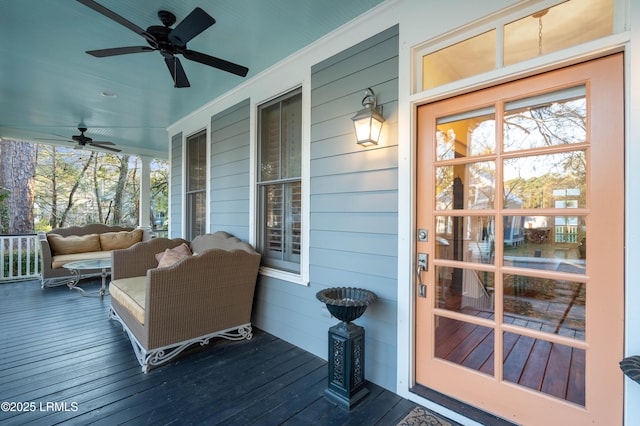 wooden terrace featuring covered porch and ceiling fan