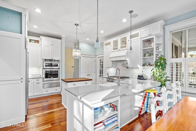 kitchen featuring a warming drawer, open shelves, wood counters, and white cabinetry