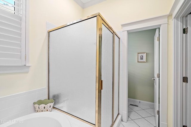 bathroom with a bathtub, tile patterned flooring, and a shower stall