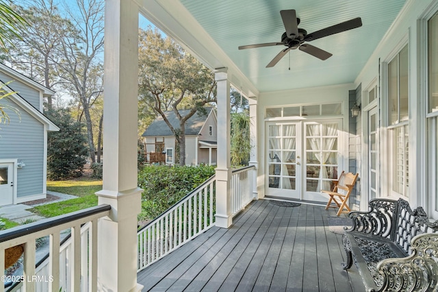 deck with covered porch, french doors, and a ceiling fan