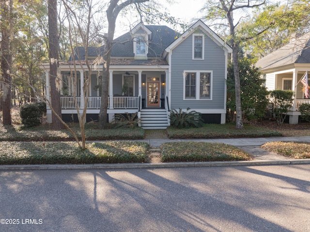 view of front of property featuring covered porch and a shingled roof