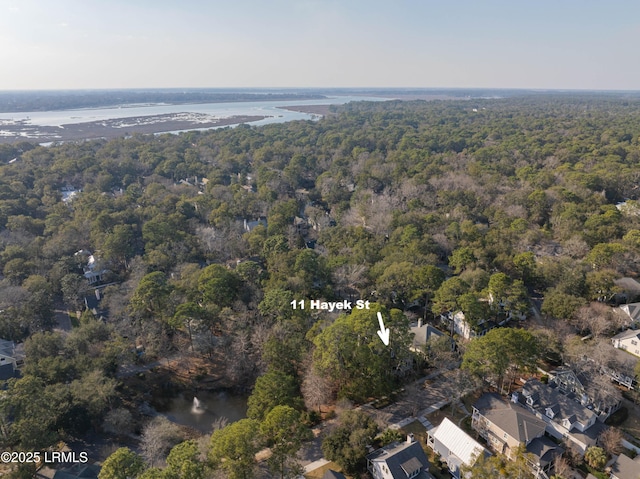 aerial view featuring a water view and a forest view