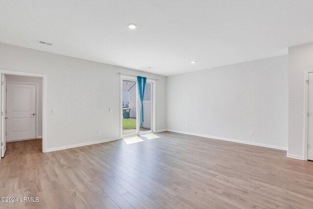 spare room with light hardwood / wood-style floors