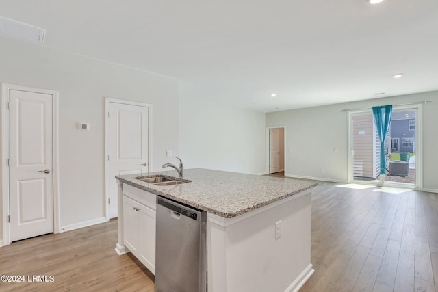 kitchen with sink, dishwasher, light stone counters, an island with sink, and white cabinets