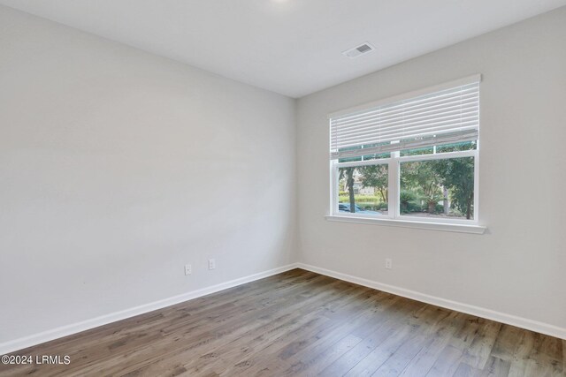 unfurnished room with wood-type flooring