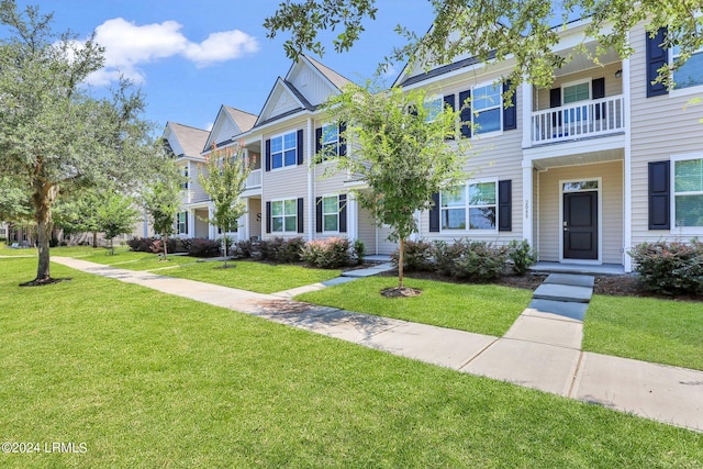 view of property featuring a front lawn