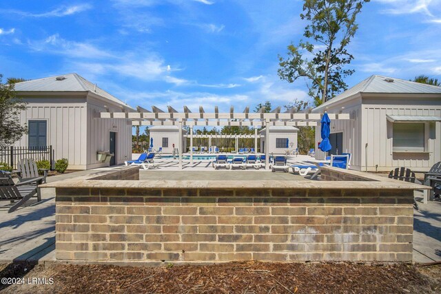 view of swimming pool featuring a patio area and an outdoor bar