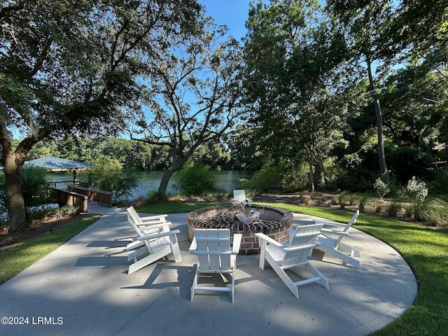 view of patio / terrace featuring a water view and an outdoor fire pit