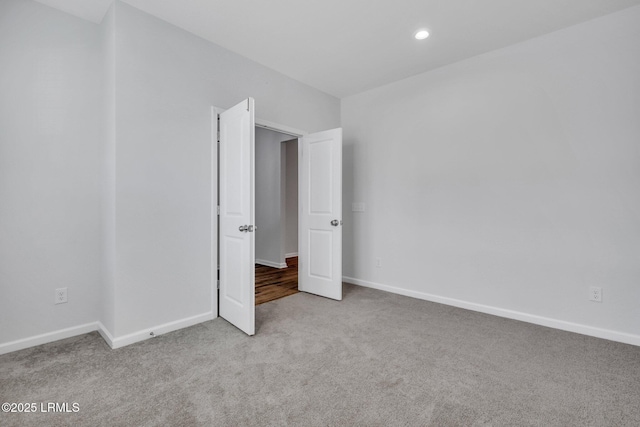 unfurnished bedroom featuring light carpet