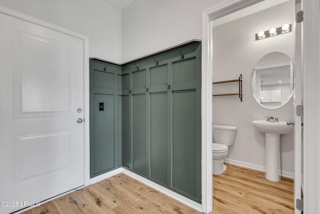 bathroom with sink, toilet, and hardwood / wood-style floors