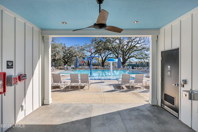 view of pool with ceiling fan and a patio