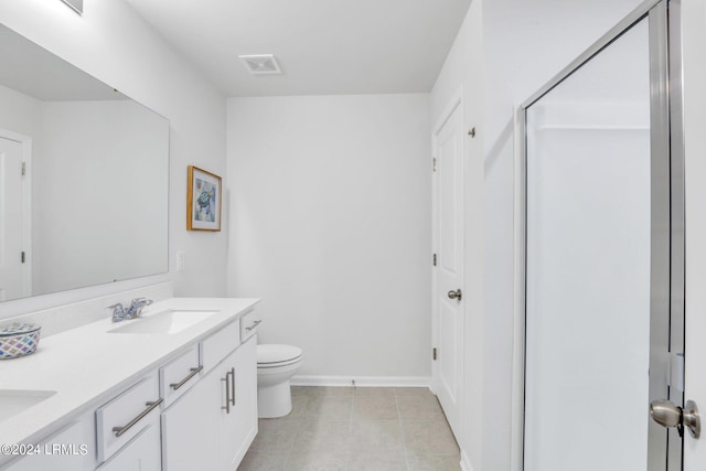 bathroom with vanity, tile patterned floors, and toilet