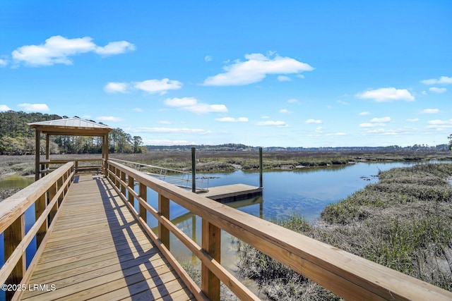 view of dock featuring a gazebo and a water view