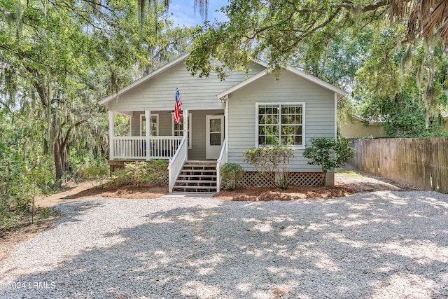 bungalow-style house with fence, a porch, and stairway