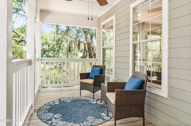 sunroom / solarium featuring plenty of natural light and ceiling fan