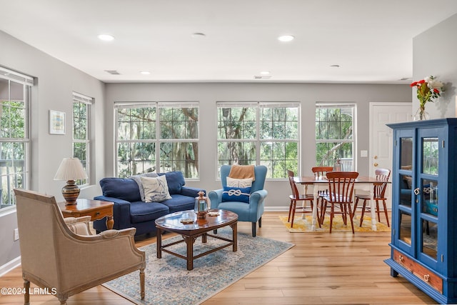 living room with light wood-style floors, recessed lighting, baseboards, and a wealth of natural light